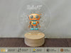 a toy robot sitting on top of a wooden table