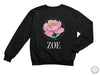 a black sweatshirt with a pink flower on it