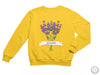 a yellow sweatshirt with a bunch of purple flowers on it