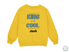 a yellow sweatshirt with the words king of cool printed on it